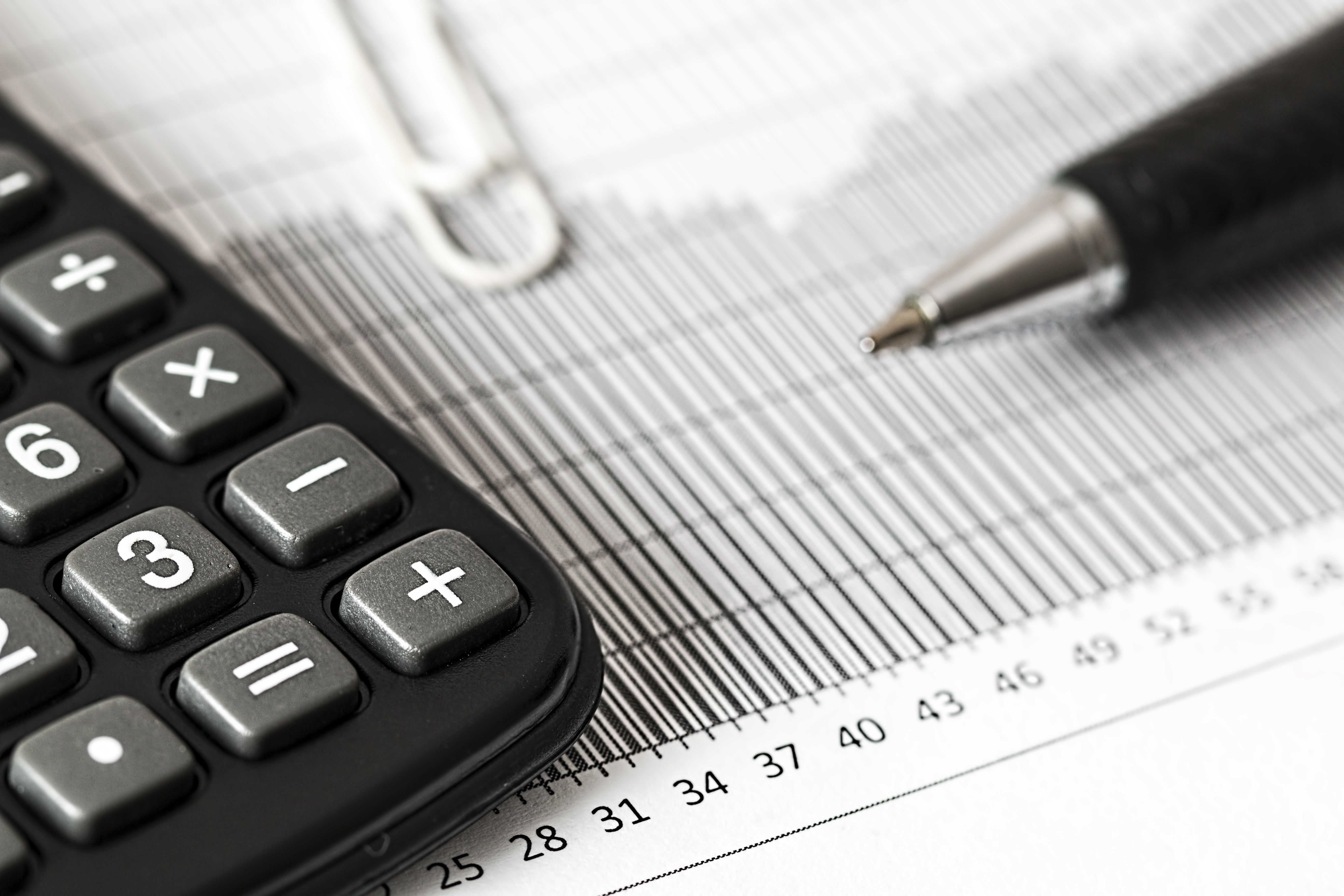 Notebook, pen, and calculator for budgeting