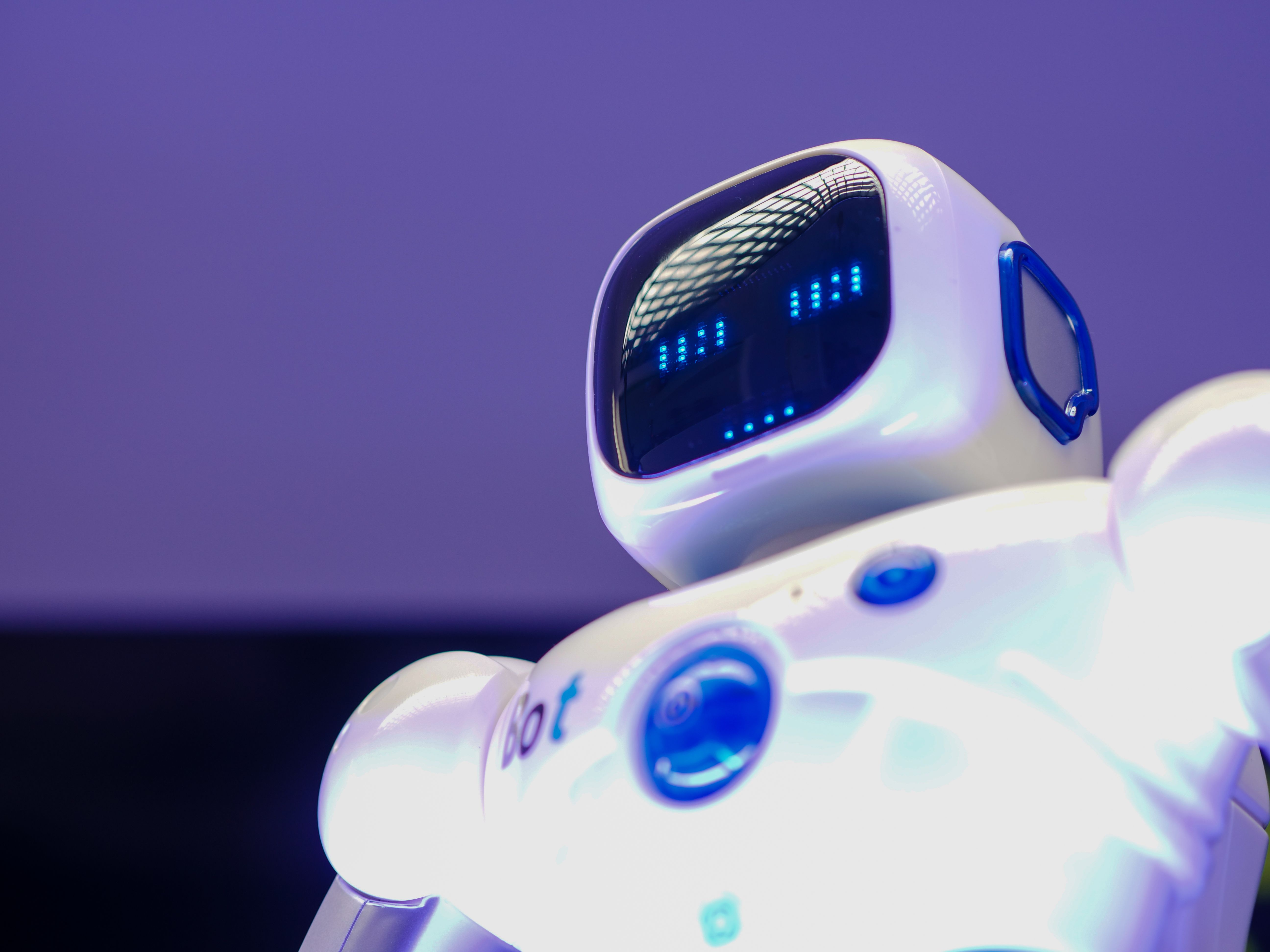 Close-up of robot hand touching keyboard representing AI job automation
